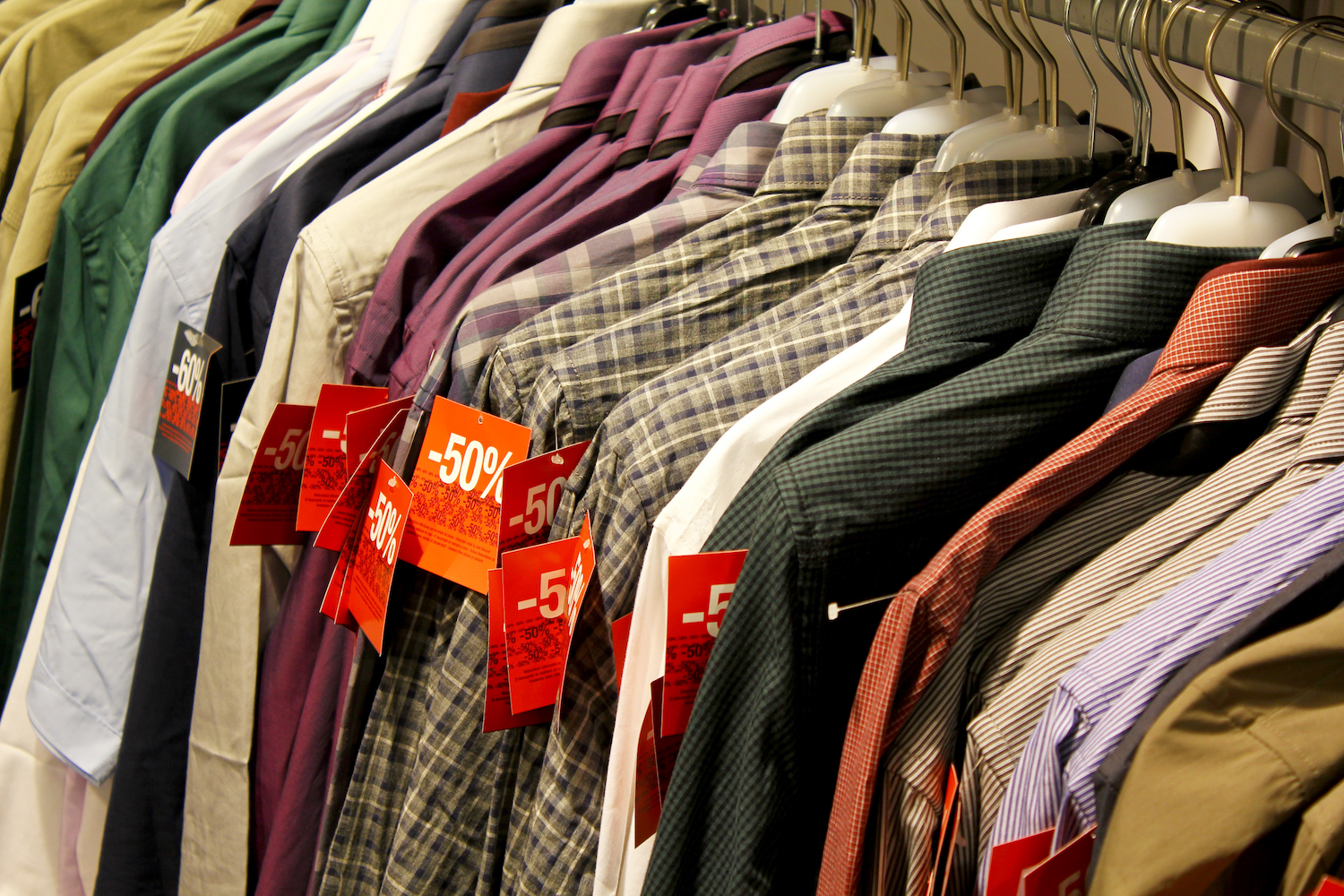 rack of fast fashion shirts on sale