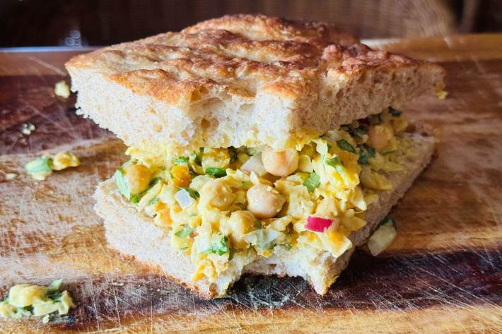 A curried chickpea salad sandwich on focaccia