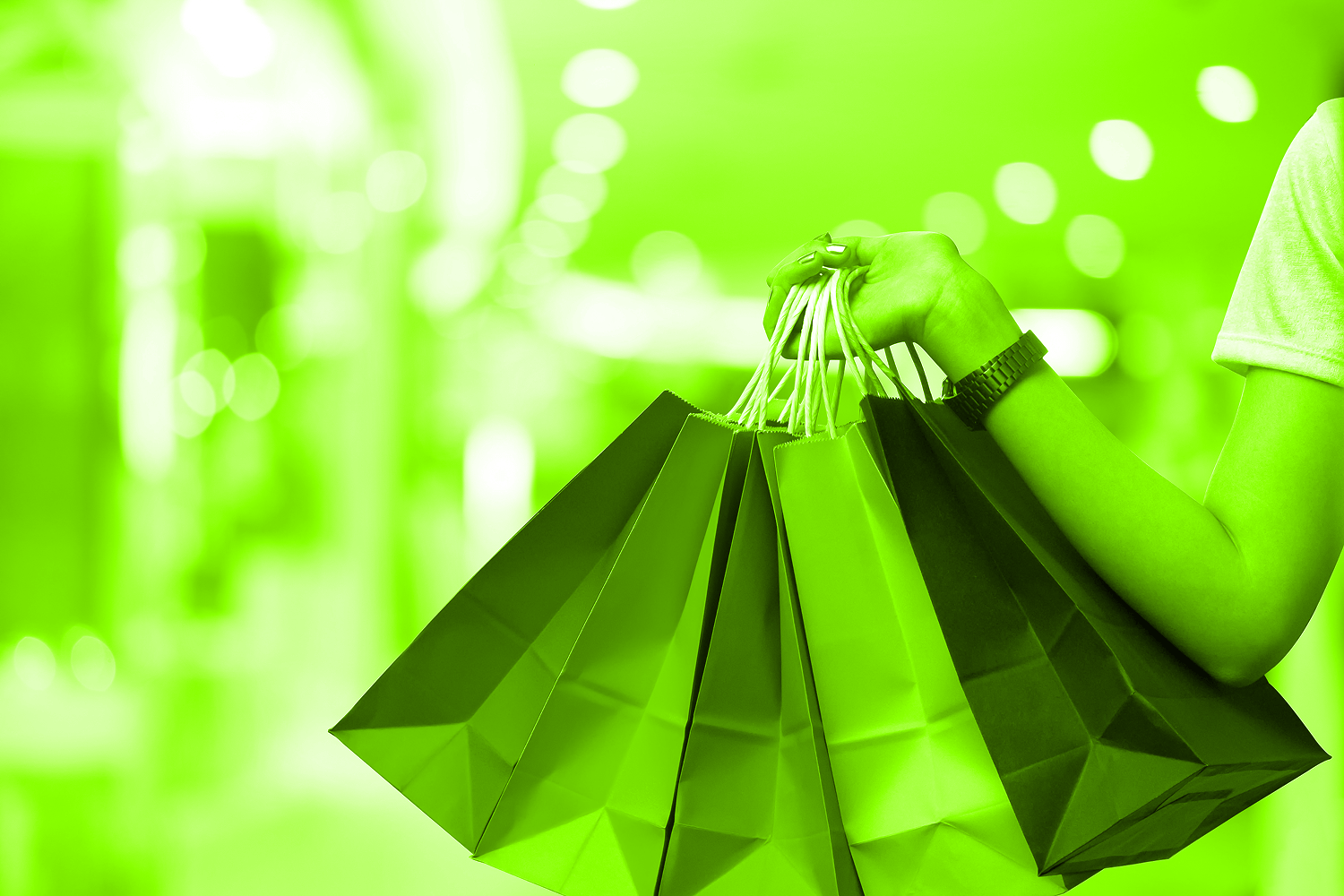 person carrying armful of shopping bags