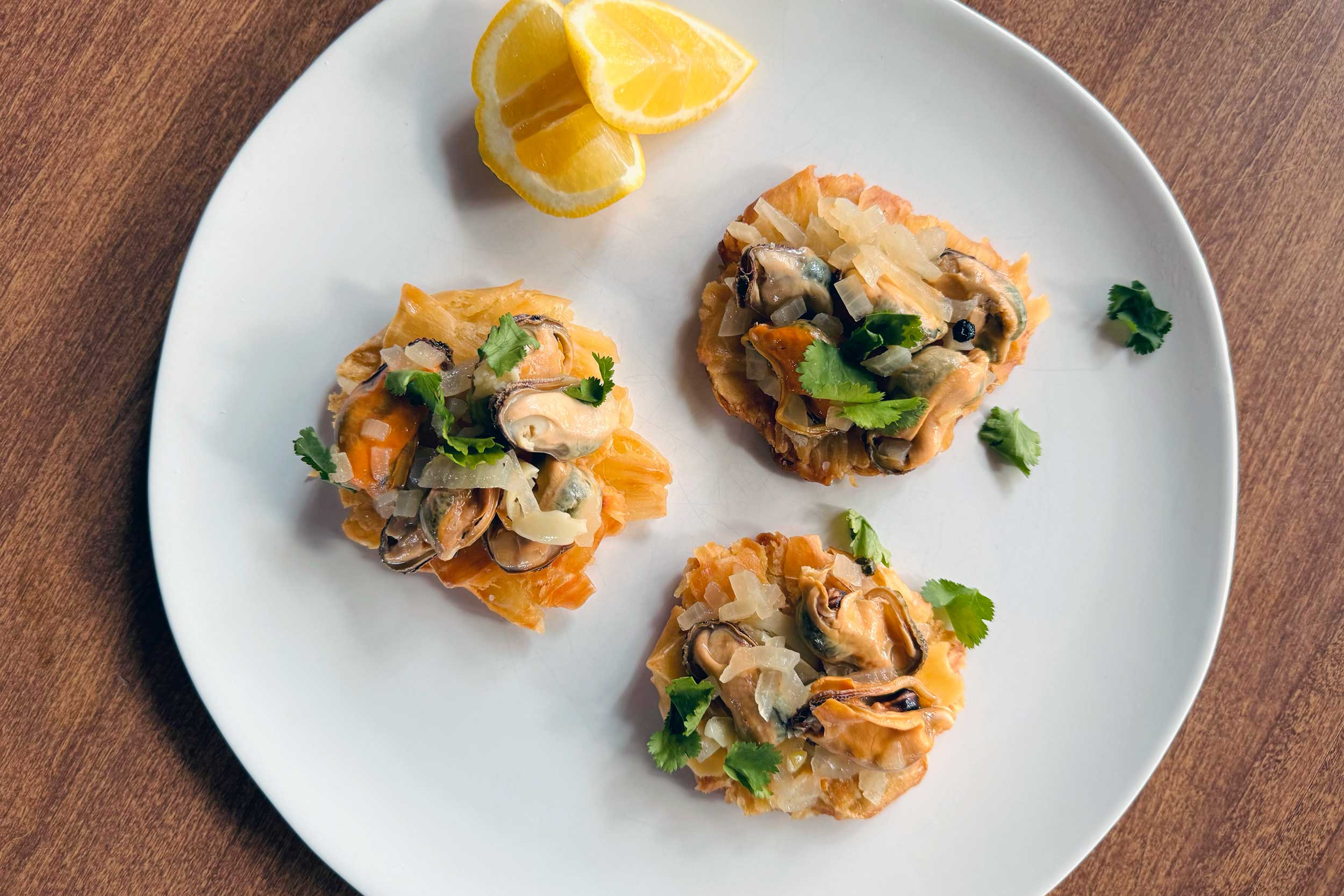 mussels escabache plated with lemon