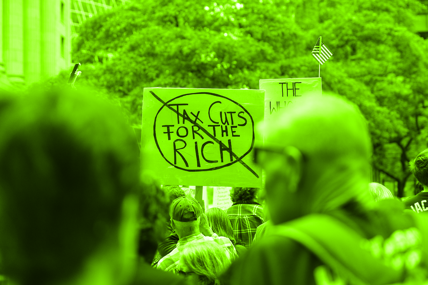 sign at protest tax cuts for rich