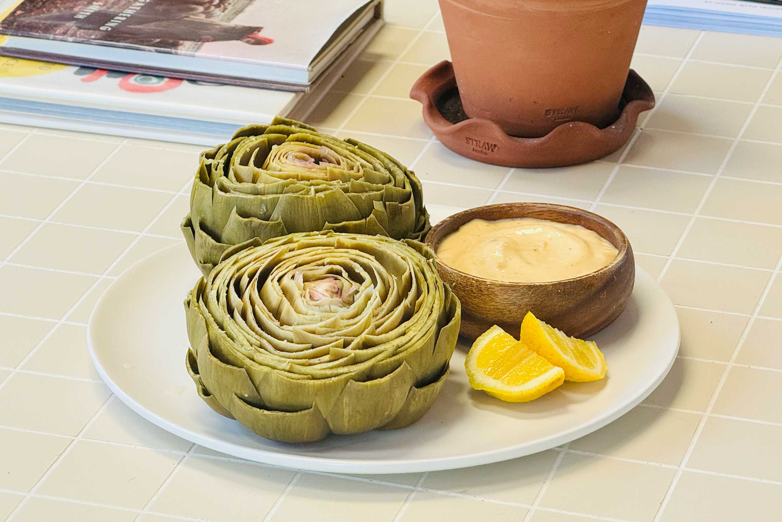 steamed artichoke with sauce and lemon