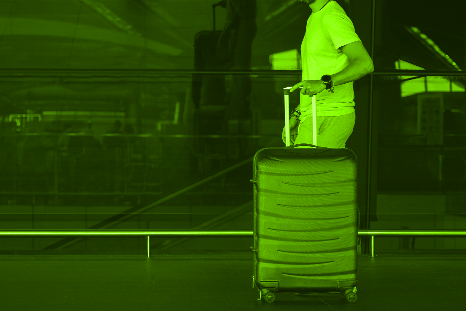 man pushing suitcase through airport