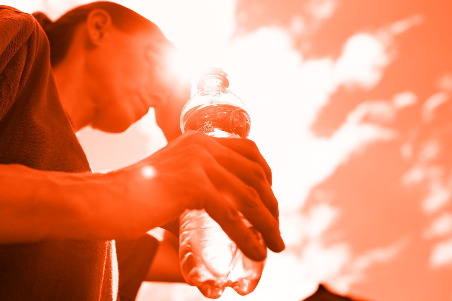 woman with water bottle in harsh sunlight