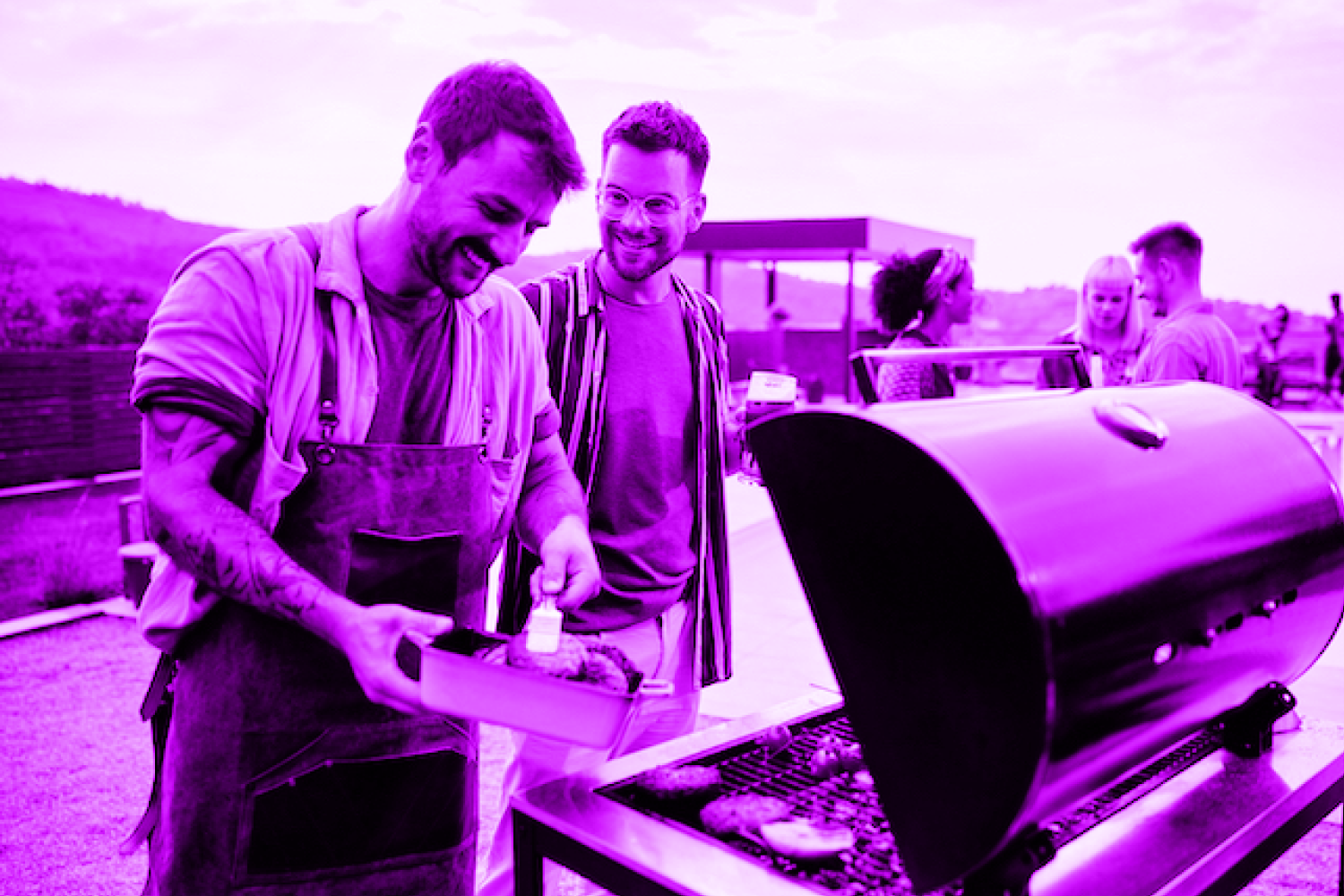 Man talking to friend while cooking on gas grill