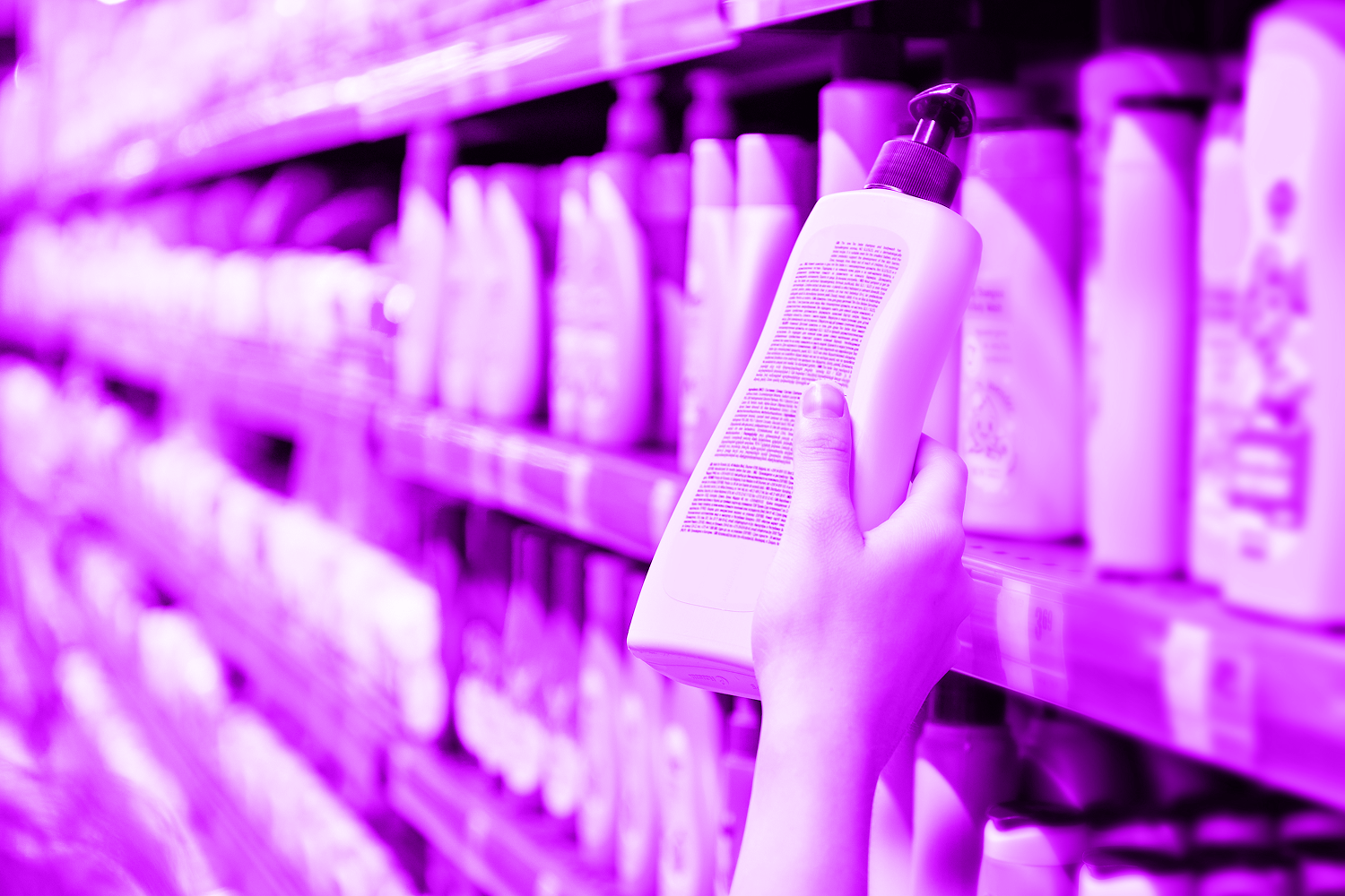 hand holding shampoo bottle in store