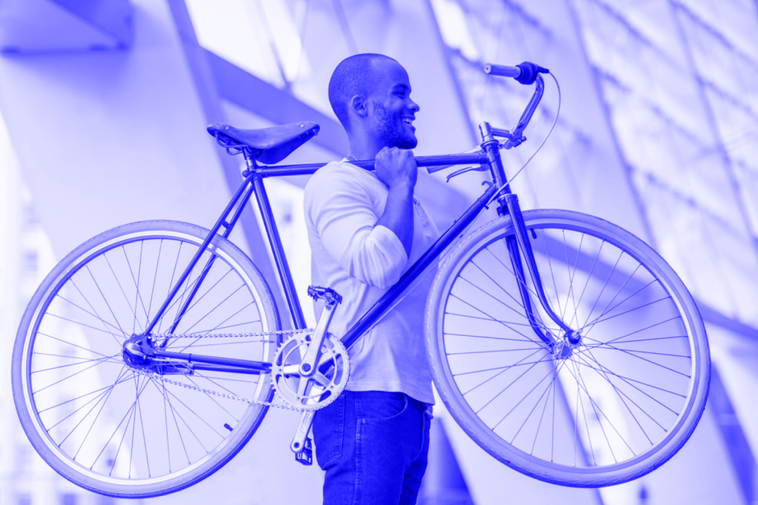 Man carrying a bike looking happy