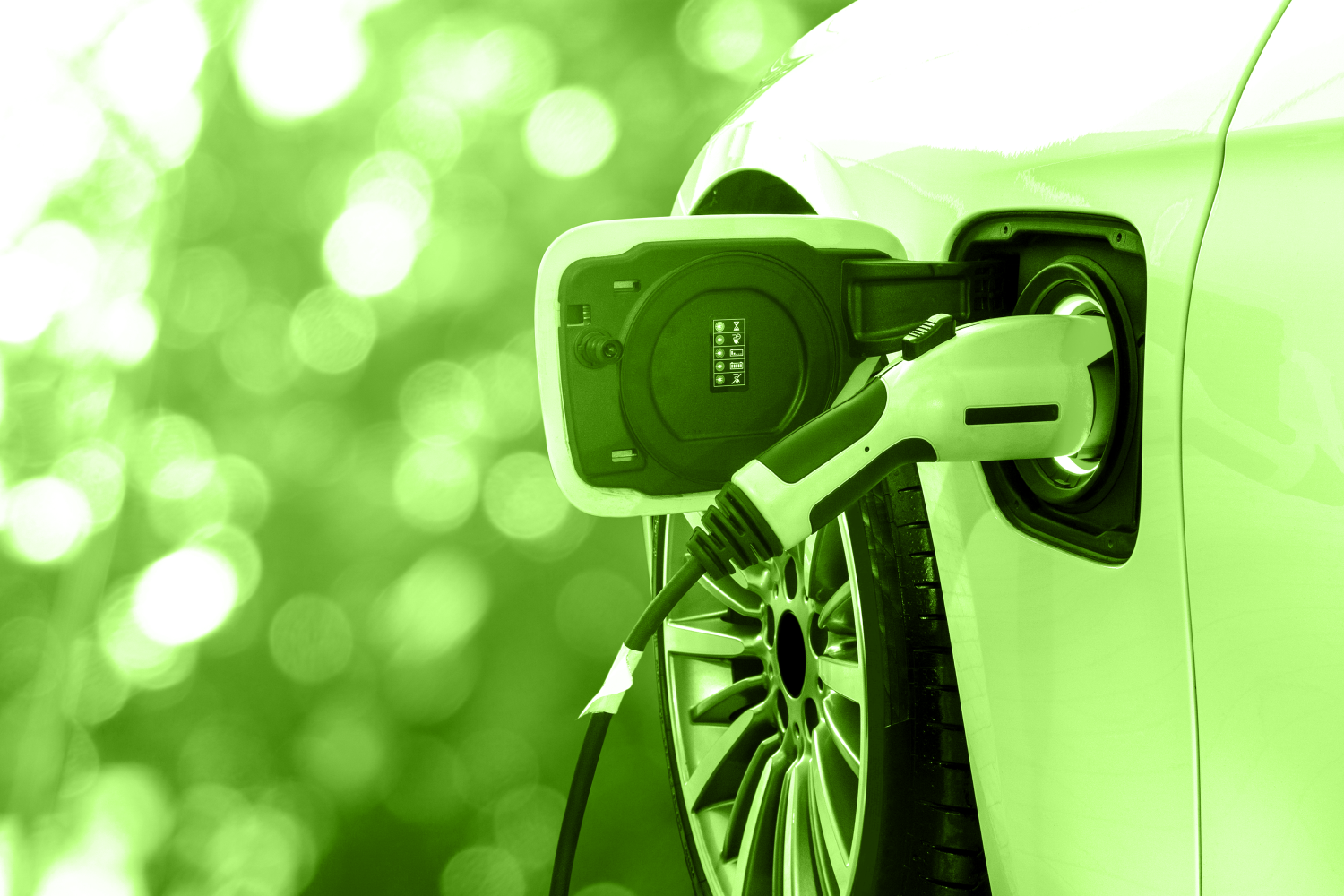 Photo of electric car charging at pump