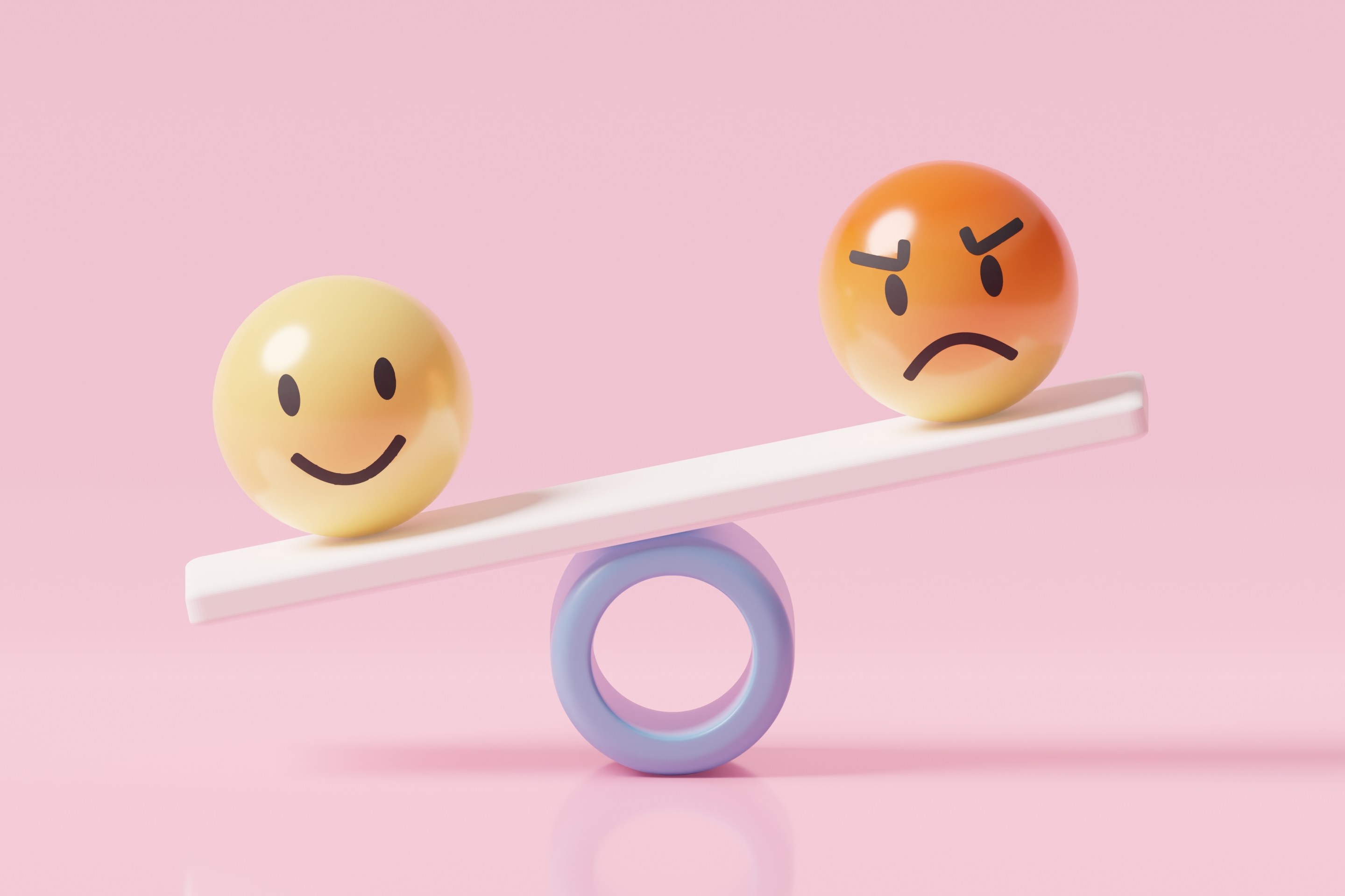 One smiley face, one angry face teetering on a seesaw