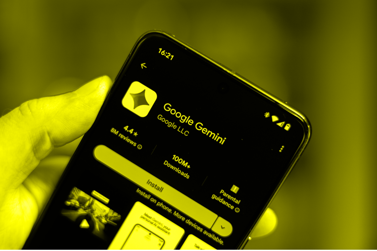 Phone in hand displaying Google Gemini app on Google Play Store