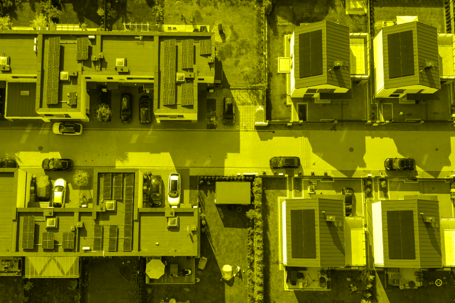 Rows of single-family houses on the city outskirts, featuring solar panels