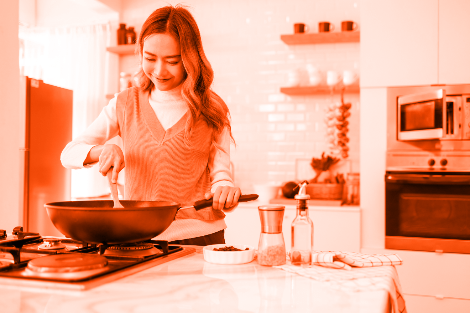 Smiling woman cooking at her stove