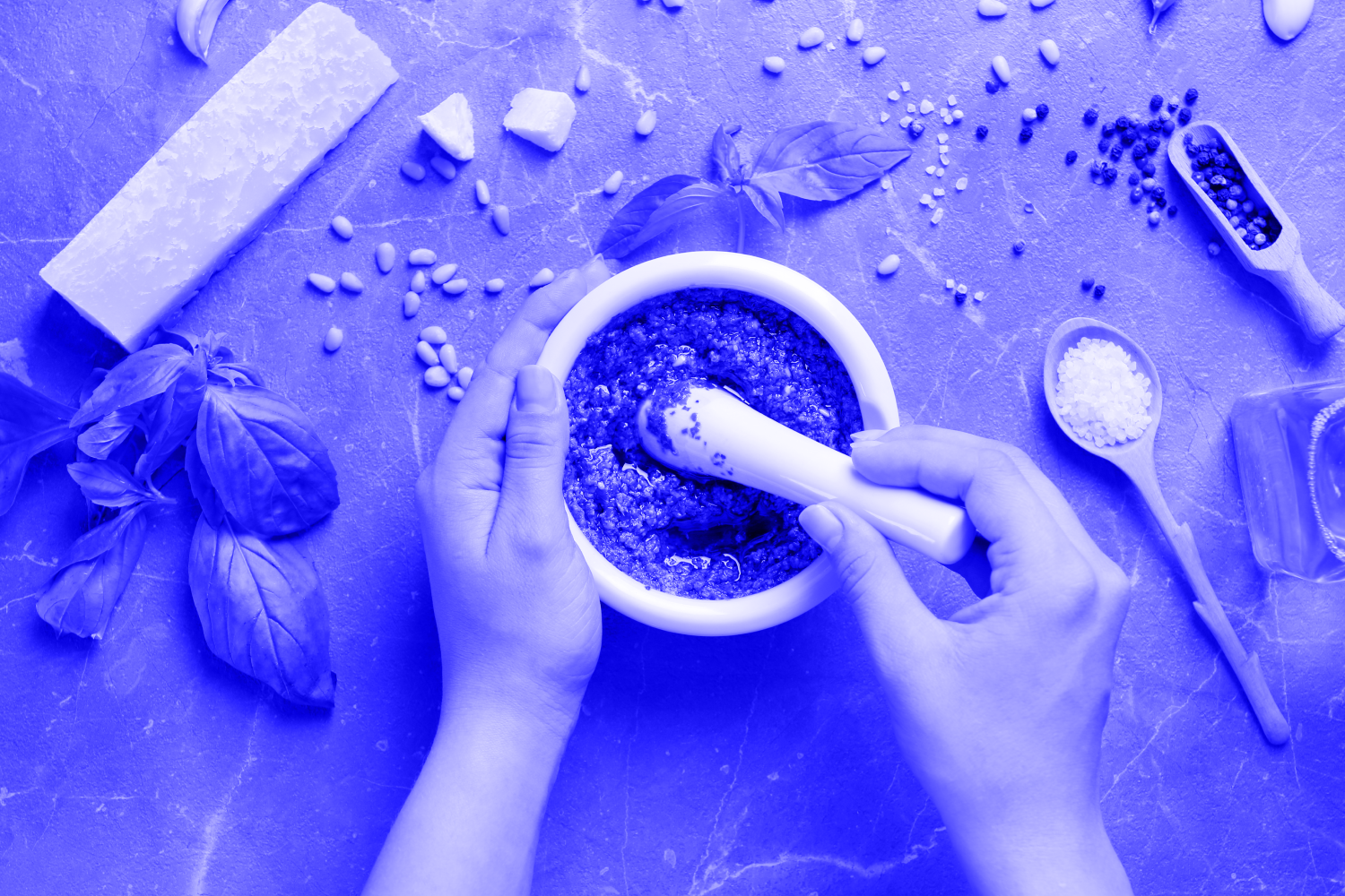 Woman using mortar and pestle to make pesto