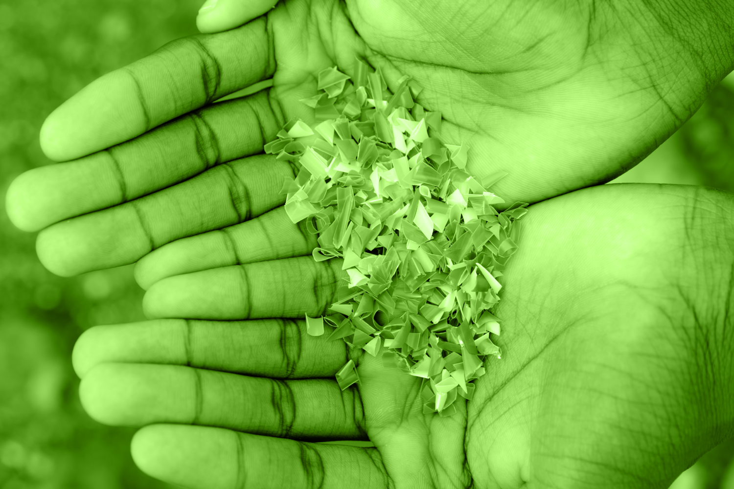 Hands full of microplastics on the beach