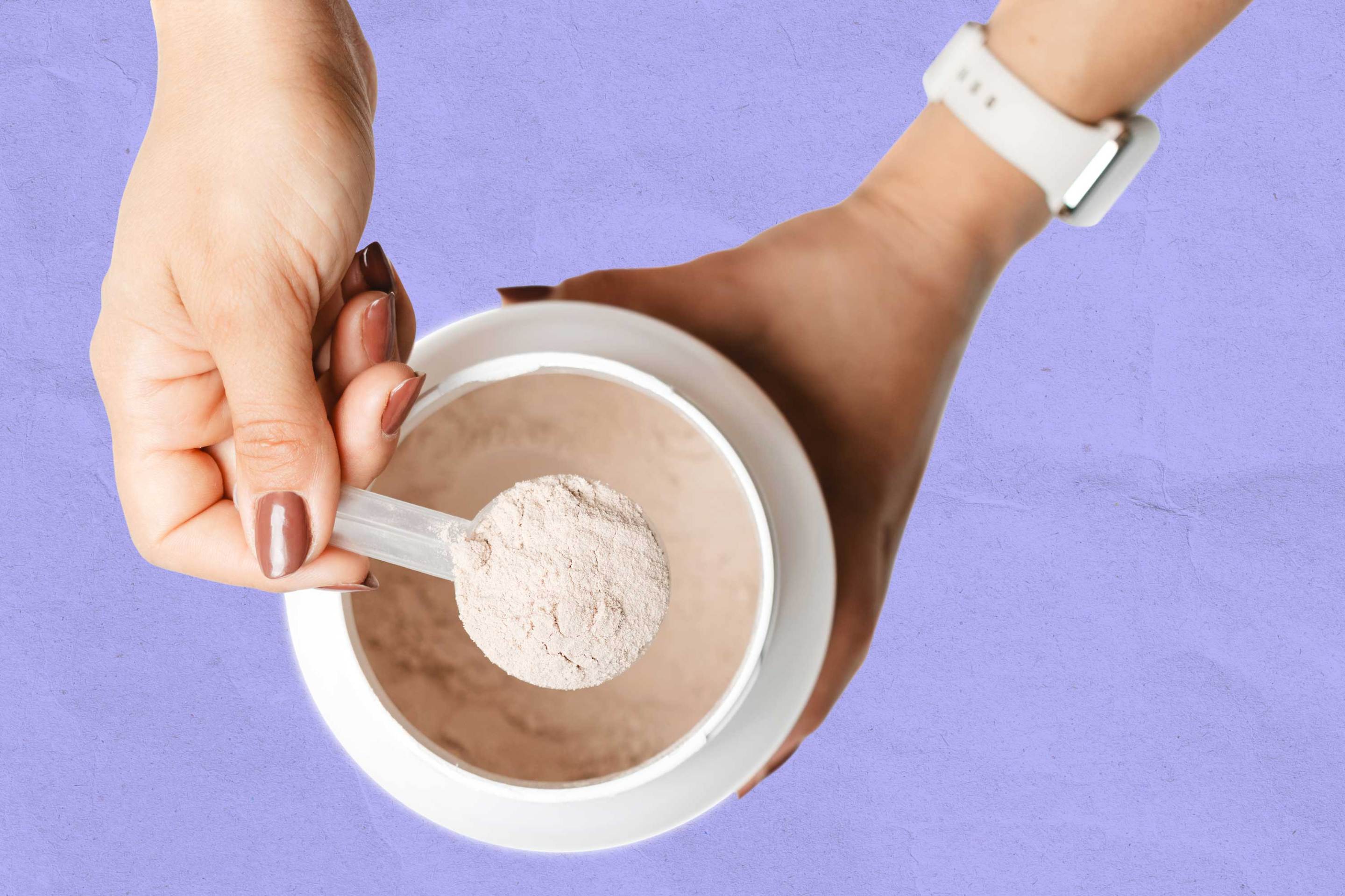 Woman's hands holding measuring spoon with protein powder over a jar
