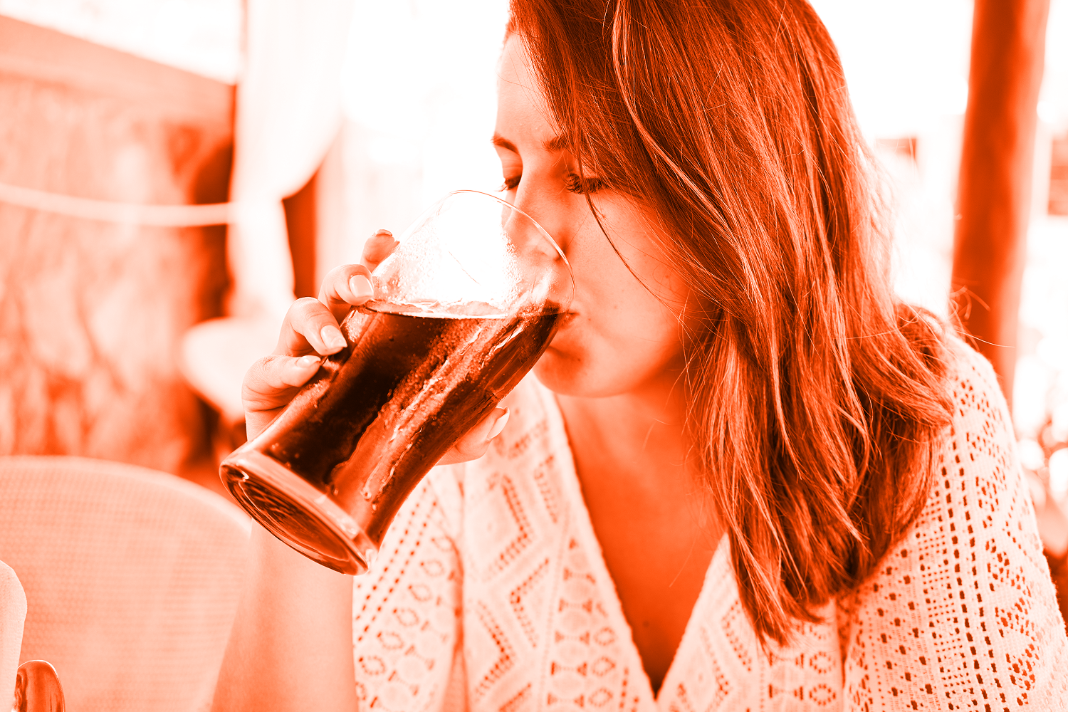 woman sitting at restaurant enjoying summer vacation drinking soda