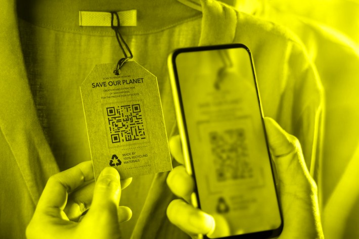 person using phone to scan eco label on shirt